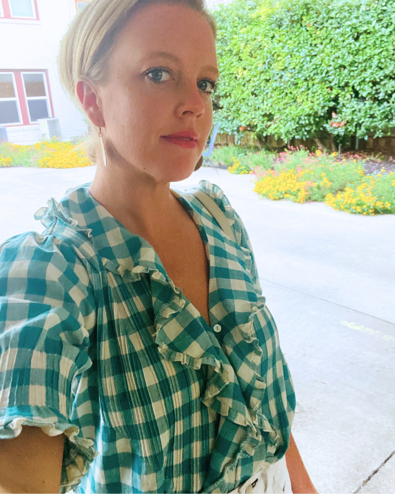 Women wearing a gingam top with ruffles